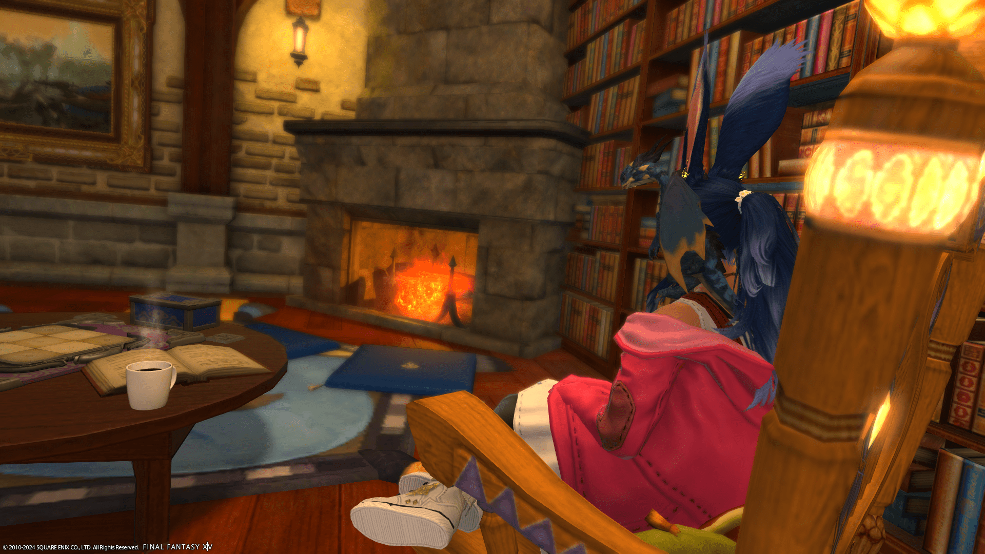 Me sitting in a rocking chair looking over at a fireplace with bookshelves off to the right and a coffee table on the left.