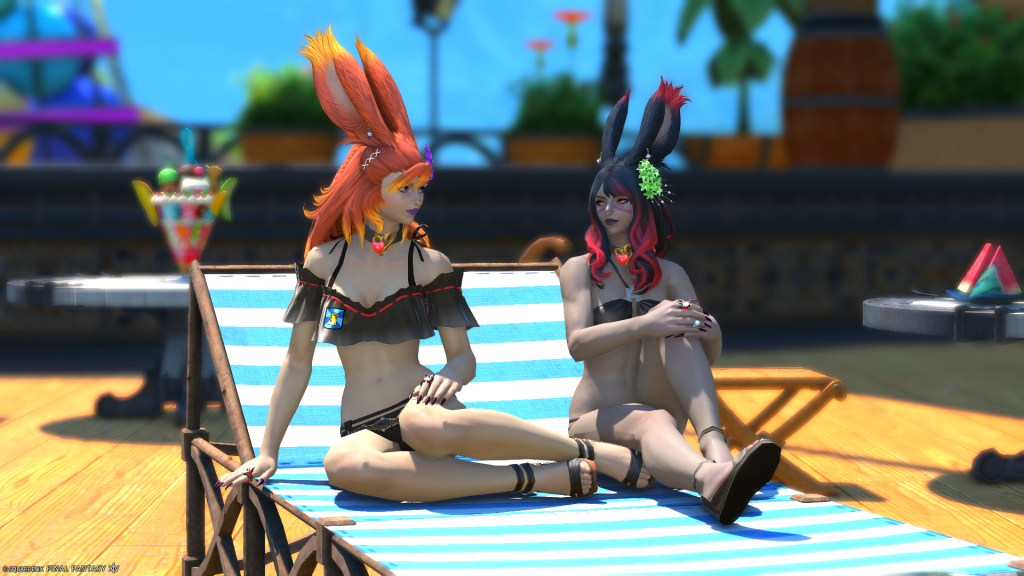 Reinylla and Elizara relaxing together on a recliner.